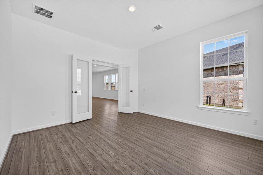 The front room features elegant double glass-pane French doors, adding both style and functionality while allowing light to flow through the space.