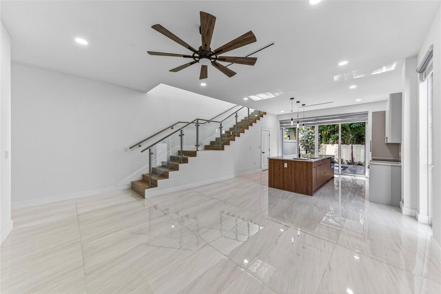 With view into Dining and Kitchen and overlooking backyard