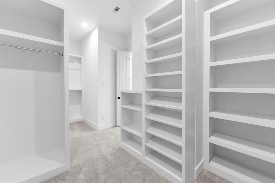 Spacious walk-in closet with ample shelving and hanging space for all your storage needs.