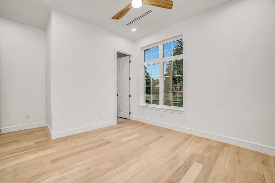 Unfurnished room with light wood-style floors, ceiling fan, and recessed lighting Unfurnished room with light wood-style floors, ceiling fan, and recessed lighting