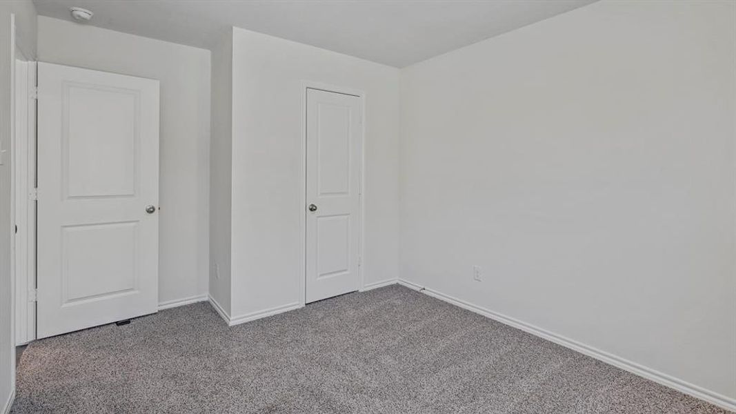 Unfurnished bedroom with baseboards and carpet floors Unfurnished bedroom with baseboards and carpet floors