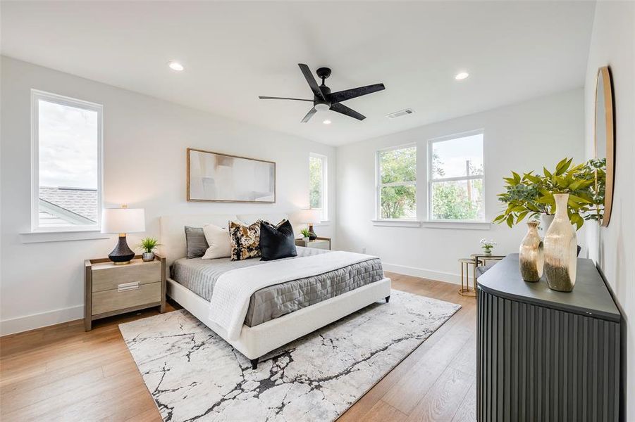 Bedroom featuring light wood-style floors, a ceiling fan, and recessed lighting Bedroom featuring light wood-style floors, a ceiling fan, and recessed lighting
