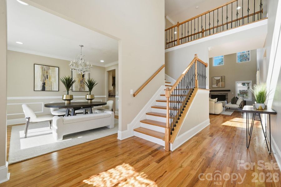 Grand two-story foyer with wrought-iron staircase and beautiful natural light. Grand two-story foyer with wrought-iron staircase and beautiful natural light.