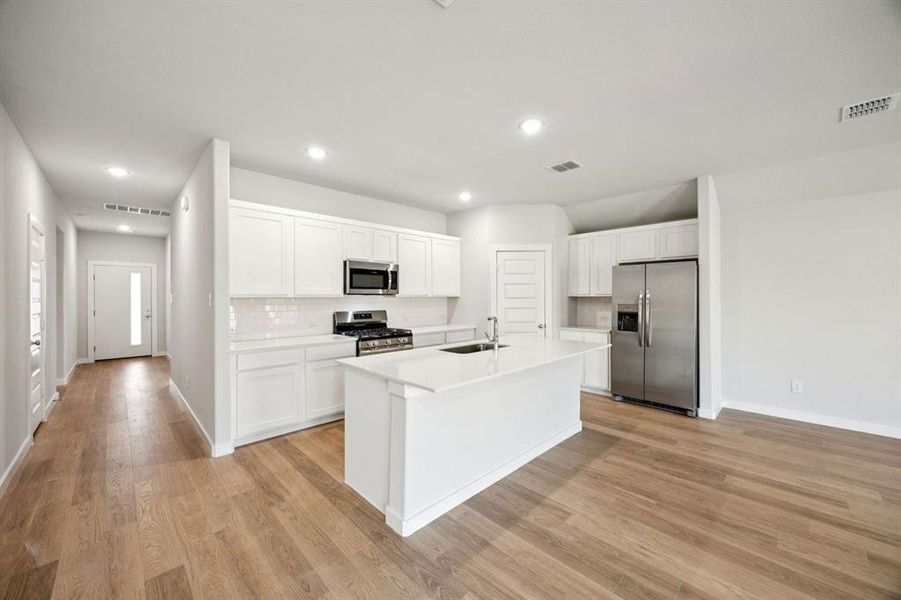 Kitchen in the Emmy II home plan by Trophy Signature Homes - REPRESENTATIVE PHOTO