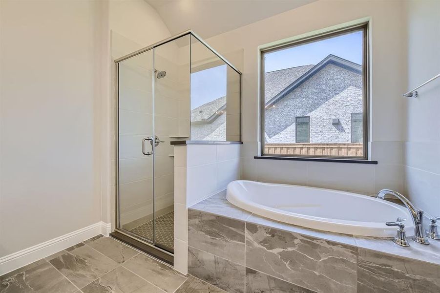 Bathroom with tile patterned flooring and separate shower and tub