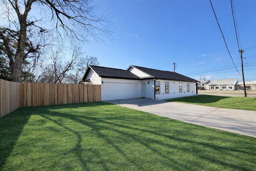 View of front facade with driveway and a garage in corner lot View of front facade with driveway and a garage in corner lot