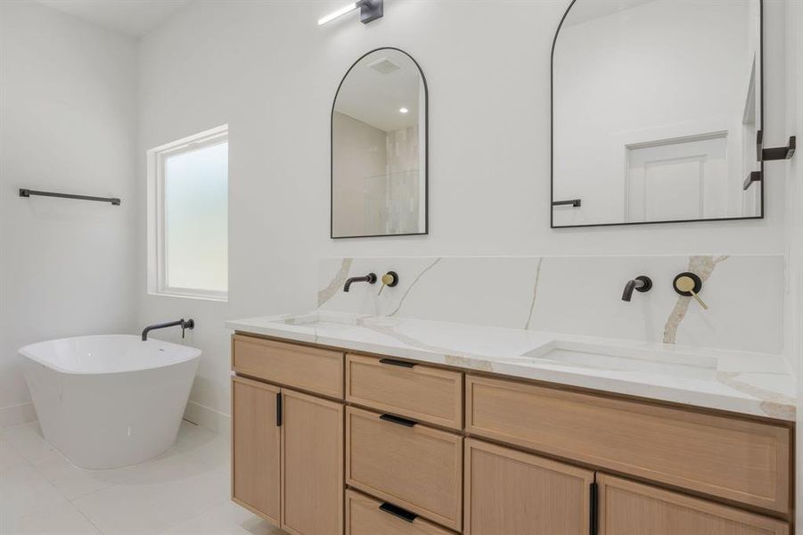 Carefully selected plumbing fixtures, designer lighting, framed mirrors, and elegant towel hardware elevate the space, creating a sophisticated bathroom retreat with a timeless and refined aesthetic. Carefully selected plumbing fixtures, designer lighting, framed mirrors, and elegant towel hardware elevate the space, creating a sophisticated bathroom retreat with a timeless and refined aesthetic.