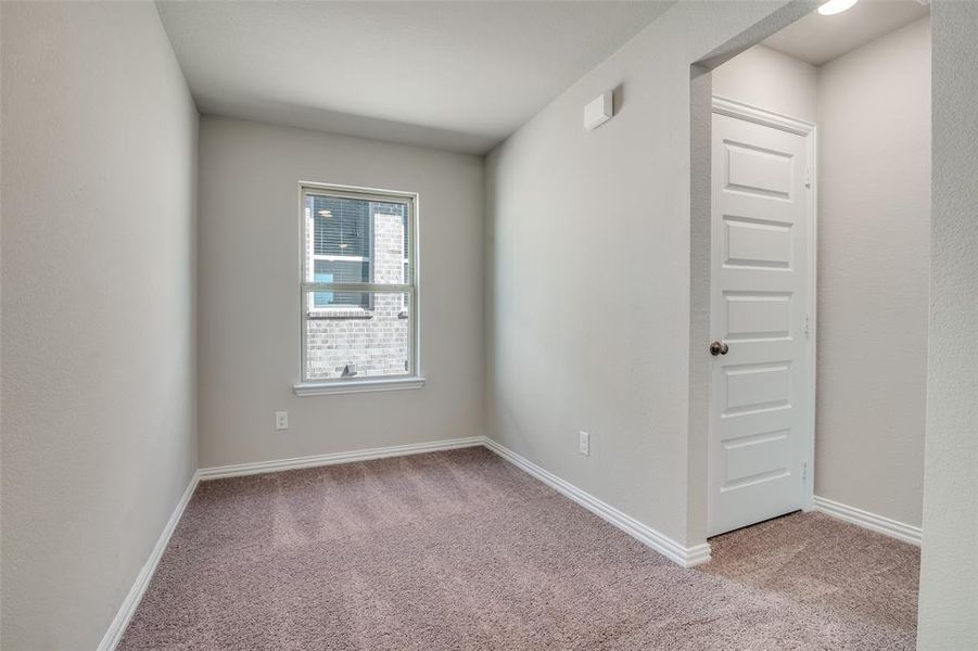 Empty room with light colored carpet and baseboards Empty room with light colored carpet and baseboards