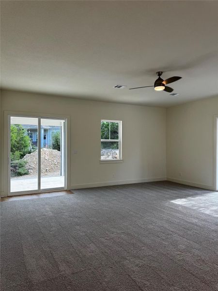 Carpeted spare room featuring baseboards and ceiling fan Carpeted spare room featuring baseboards and ceiling fan