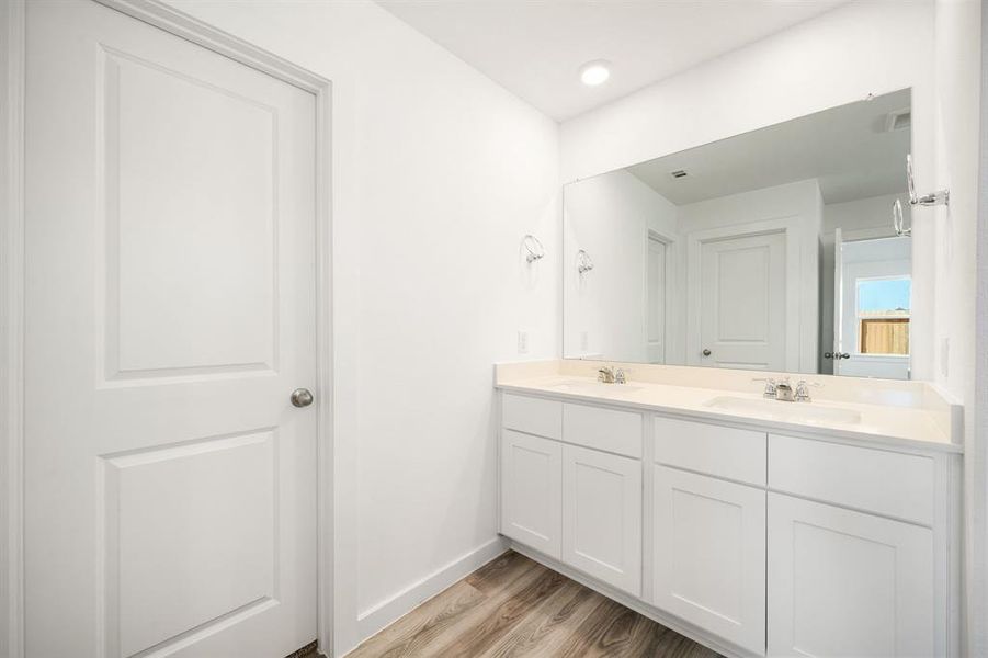 This primary bathroom is definitely move-in ready! Featuring a spa like walk-in shower with tile surround, separate garden tub for soaking after a long day with custom tile detailing, bright cabinets with light countertops, spacious walk-in closet with shelving, high ceilings, custom paint, sleek and modern finishes.