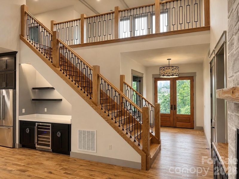 Dramatic foyer showcasing custom staircase and architectural railing details