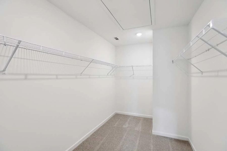 Sample Photo: Primary Bedroom Walk-In Closet Sample Photo: Primary Bedroom Walk-In Closet