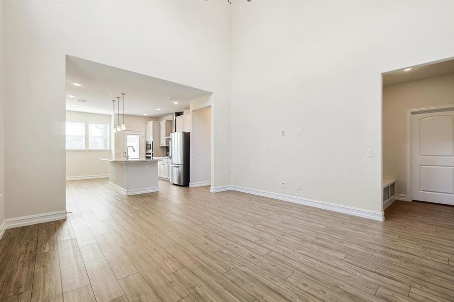 Unfurnished living room with light hardwood / wood-style flooring and sink