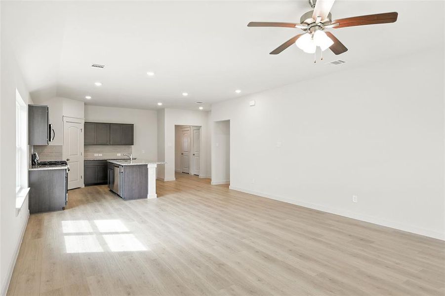Unfurnished living room featuring light wood-style flooring, recessed lighting, and a ceiling fan