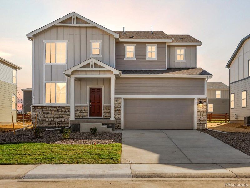 Front exterior of a new home in Revere at Johnstown, Johnstown, CO, highlighting curb appeal (Image 1).