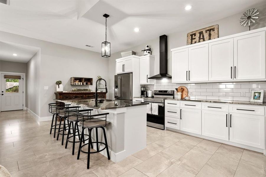 Large Kitchen Island allows for four barstools perfect for early morning breakfast.