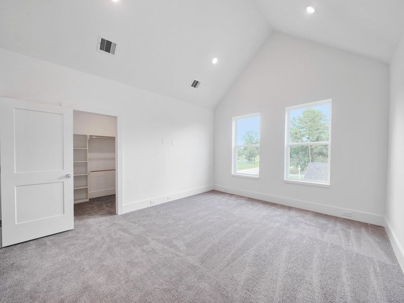Experience the airy elegance of this spacious, light-filled room, featuring high ceilings and a walk-in closet, representative of the community's inviting and modern designs.Photo Disclaimer: Photos are representative of the community and may depict a similar floor plan, model home, or previously completed residence.