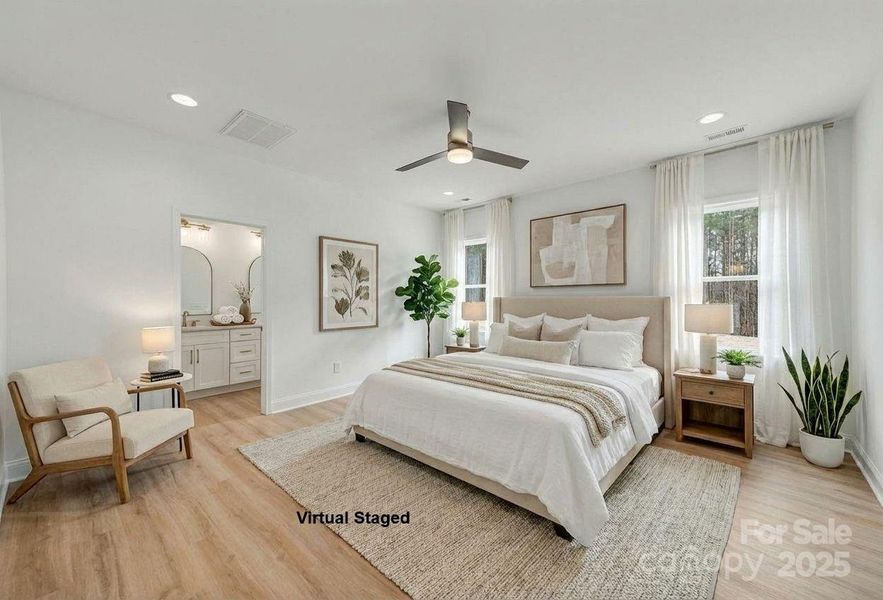 Spacious primary suite on the main level, complete with a bathroom and a walk-in closet. Spacious primary suite on the main level, complete with a bathroom and a walk-in closet.