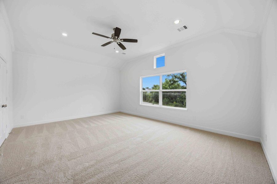 Your serene haven awaits. A vaulted ceiling and access to two closets and an en suite bathroom enhance the luxury of this spacious retreat.