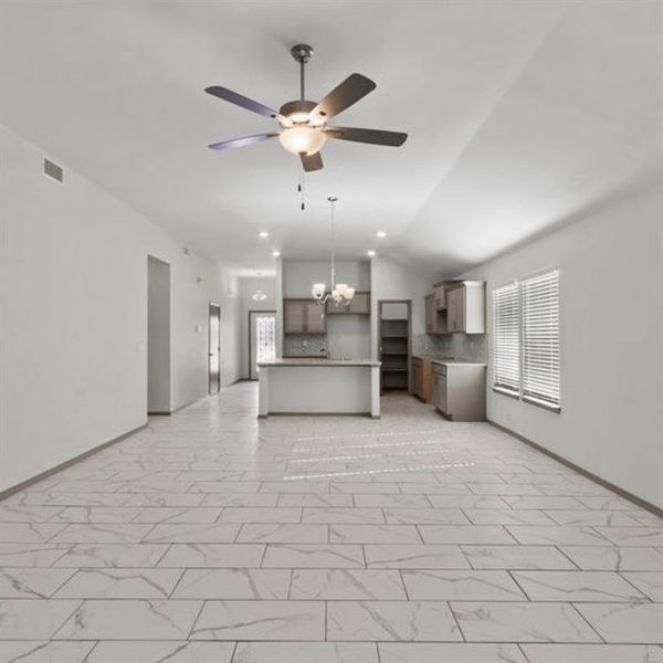 The home features loft ceilings, elegant lighting fixtures and recessed lighting complimenting the large windows allowing for an abundance of light. **This image is from another Saratoga Home with similar floor plan - Myrtle Floorplan.**