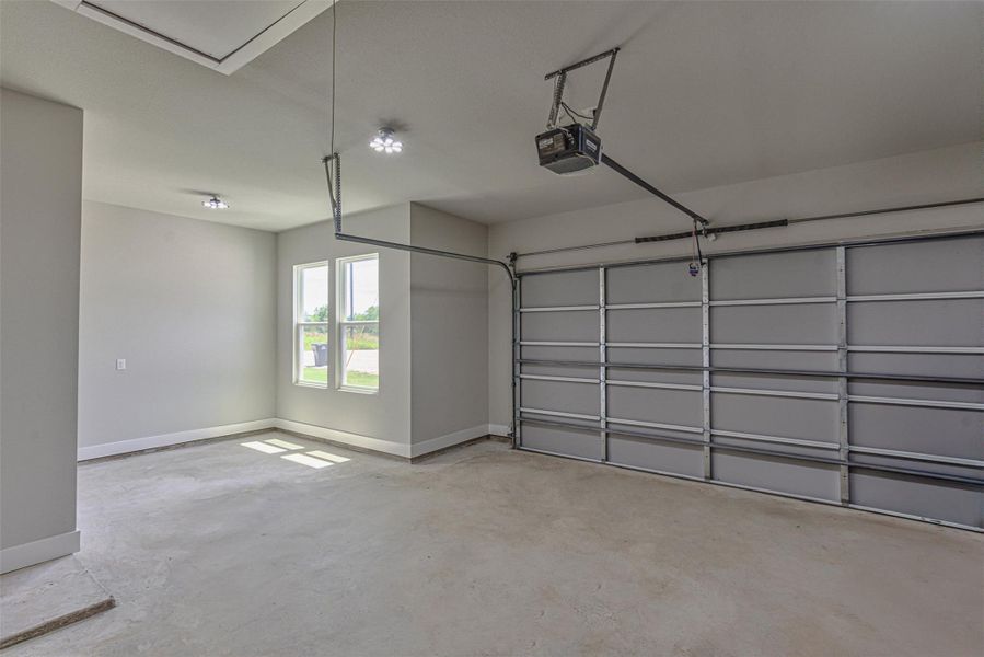 Garage with plenty of space for golf cart or workspace.