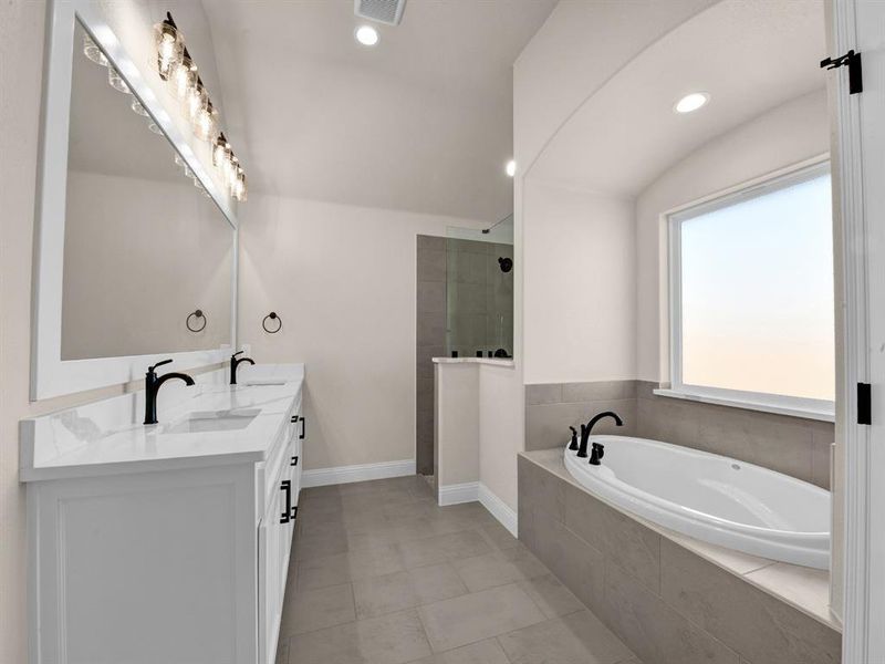 Bathroom with tile patterned flooring, plus walk in shower, and vanity