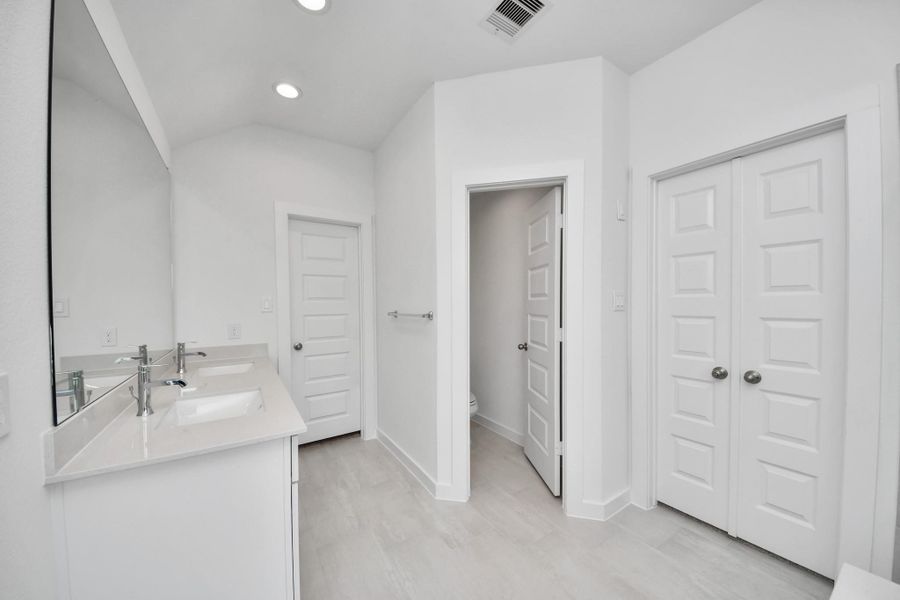 Elevate your daily routine at the elegant vanity, now equipped with double sinks, light countertops, modern hardware, and beautiful recessed lights. Elevate your daily routine at the elegant vanity, now equipped with double sinks, light countertops, modern hardware, and beautiful recessed lights.