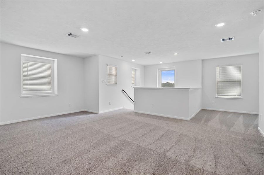 Come upstairs and enjoy a day of leisure in this fabulous game room! This is the perfect hangout spot or adult game room, this space features plush carpet, high ceiling, recessed lighting and custom paint.