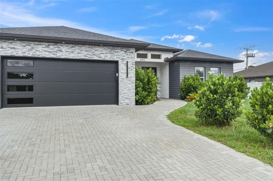 Front exterior of a new home in , North Port, FL, highlighting curb appeal (Image 2). Front exterior of a new home in , North Port, FL, highlighting curb appeal (Image 2).