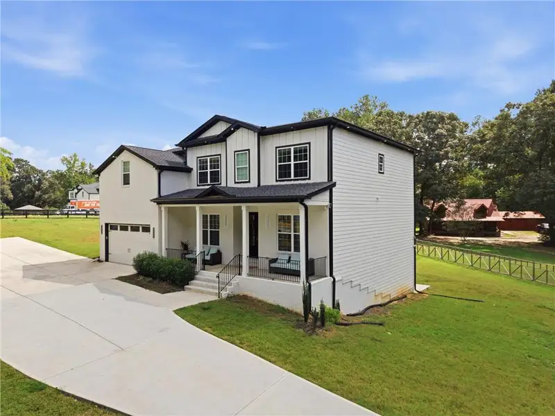 Front exterior of a new home in , Snellville, GA, highlighting curb appeal (Image 1). Front exterior of a new home in , Snellville, GA, highlighting curb appeal (Image 1).