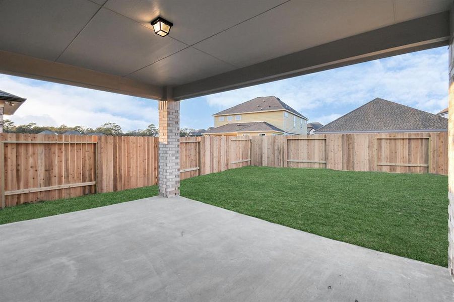 Experience outdoor living at its finest on this expansive covered patio, thoughtfully designed for BBQs and delightful outdoor dining. Sample photo of completed home. Actual colors and selections will vary.