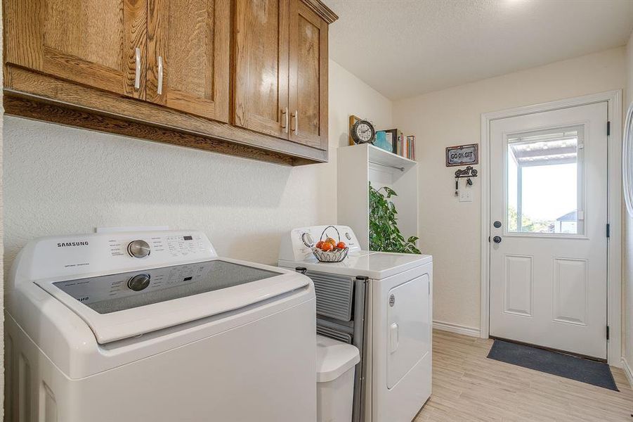 Laundry room featuring tile flooring, built-in cabinet space, and washing machine and dryer. Pantry and storage closet in laundry room. Laundry room featuring tile flooring, built-in cabinet space, and washing machine and dryer. Pantry and storage closet in laundry room.