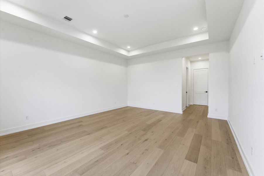 Another view of the primary bedroom with 11 ft ceilings.