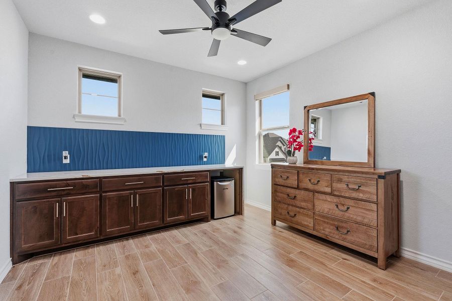 Well-lit room featuring wood-look tile flooring and bright windows. Well-lit room featuring wood-look tile flooring and bright windows.