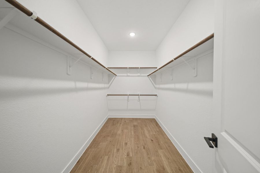Walk-in closet in the primary suite (*Photo not of actual home and used for illustration purposes only.) Walk-in closet in the primary suite (*Photo not of actual home and used for illustration purposes only.)