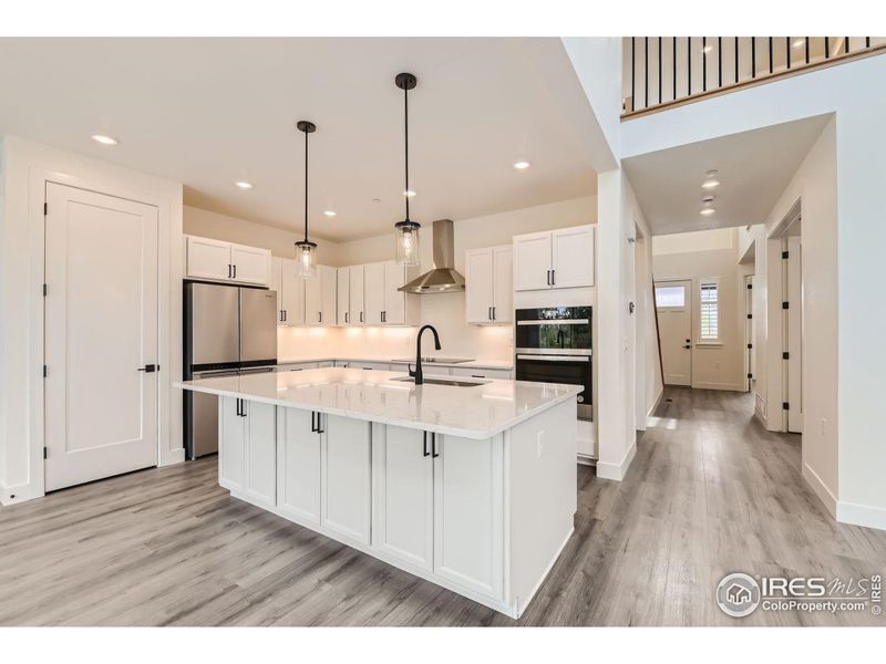 Cooks and entertainers kitchen with big island, breakfast bar, quartz counters.