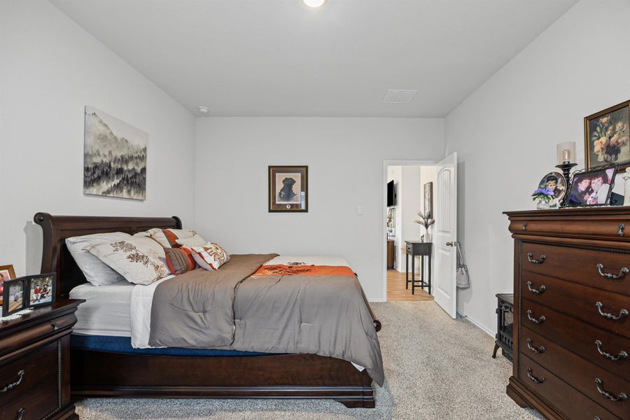 Bedroom featuring light carpet and baseboards