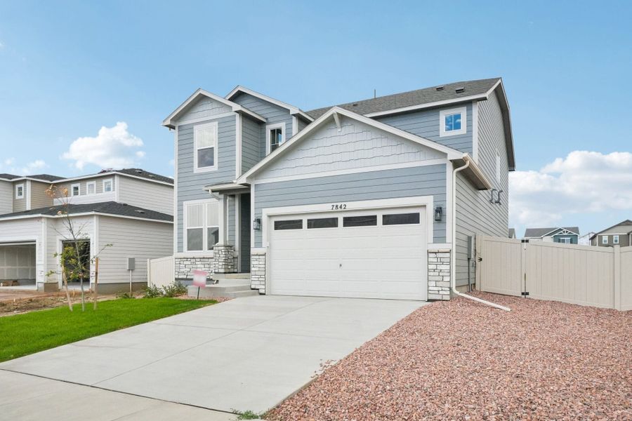 Front exterior of a new home in The Trails at Aspen Ridge, Colorado Springs, CO, highlighting curb appeal (Image 2).