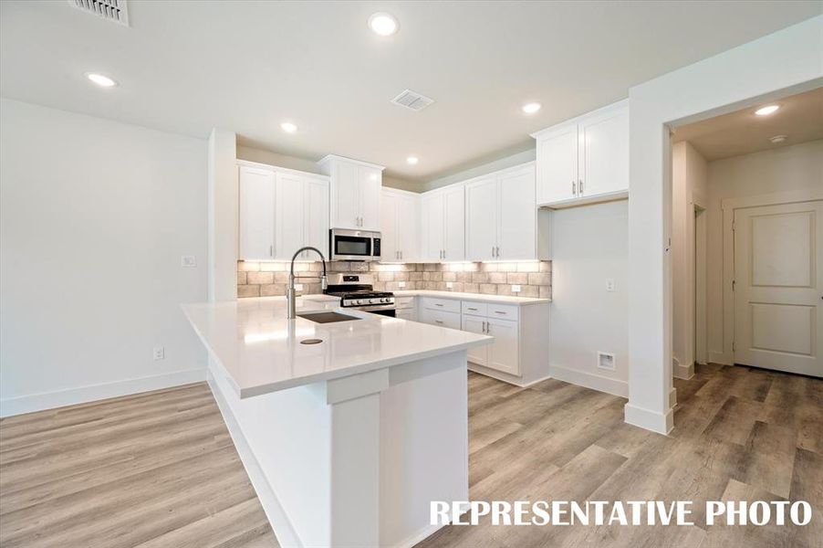 The kitchen of your dreams features fantastic storage, plenty of prep space and a breakfast bar that can do double duty as a homework station or place to grab a quick bite.  REPRESENTATIVE PHOTO