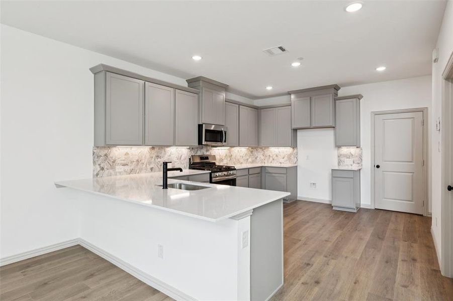 The kitchen peninsula with breakfast bar makes this the perfect place to grab a quick bite.