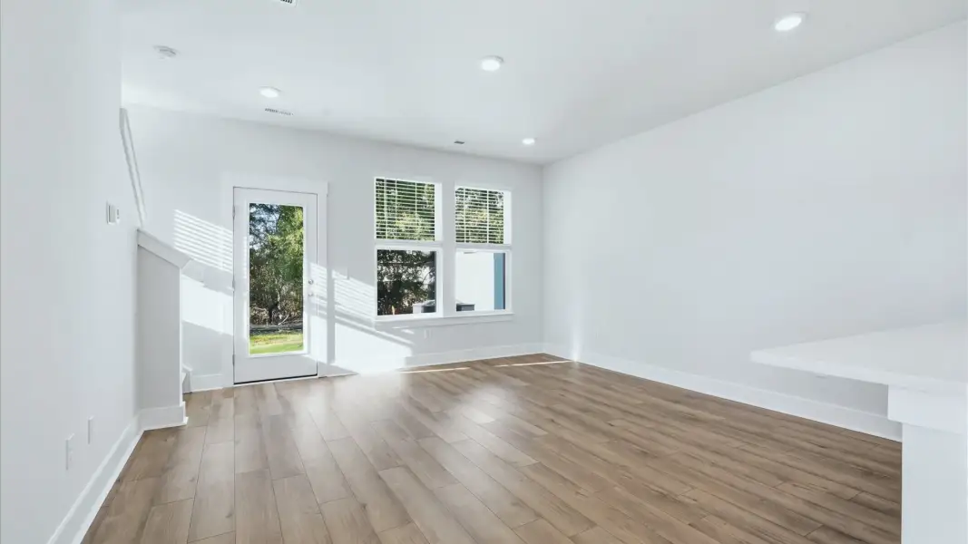 Vibrant and welcoming family room anchored by clean lines, tasteful materials, and abundant light at Clarke Townes