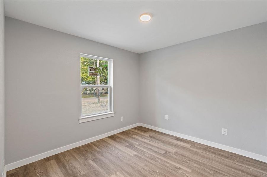 Spare room featuring light wood-type flooring