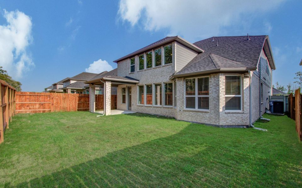 Exterior details and patio area of a home in Harper's Preserve - Classic Series, Conroe (Image 2). Exterior details and patio area of a home in Harper's Preserve - Classic Series, Conroe (Image 2).