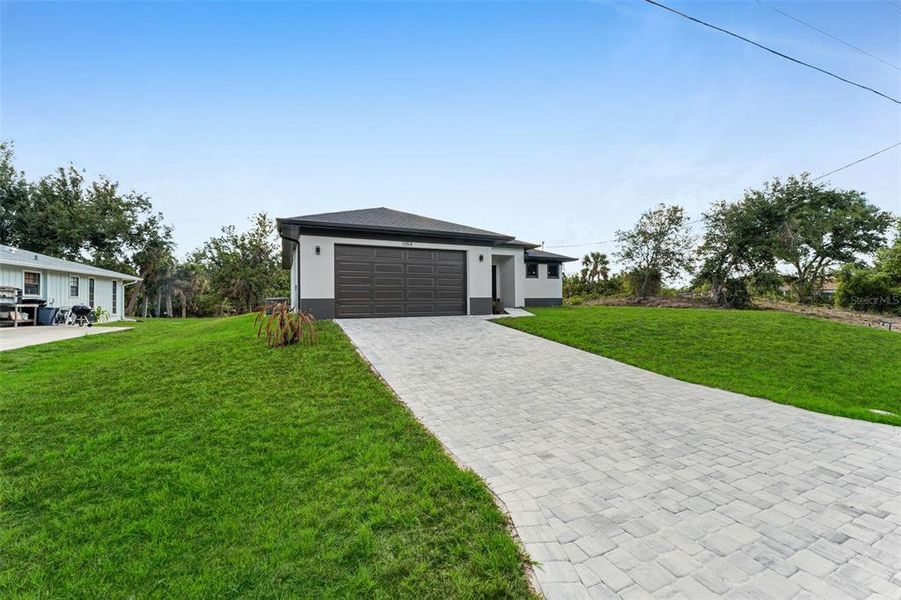Front exterior of a new home in , Englewood, FL, highlighting curb appeal (Image 15).