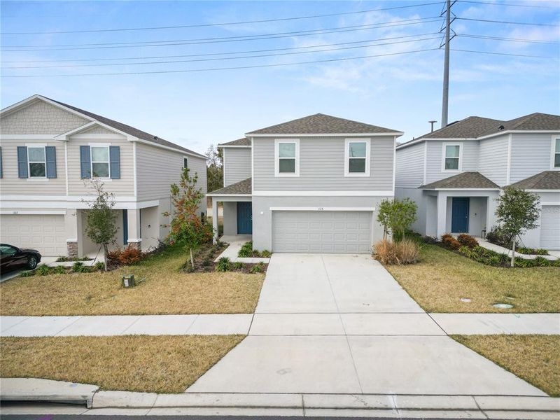 Front exterior of a new home in Marion Creek, Haines City, FL, highlighting curb appeal (Image 1). Front exterior of a new home in Marion Creek, Haines City, FL, highlighting curb appeal (Image 1).