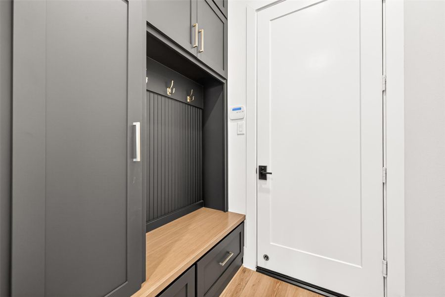Near the oversized three-car garage entrance, a custom mudroom with built-in storage provides everyday convenience.