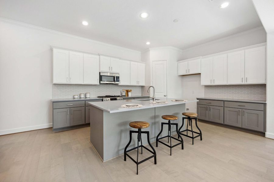 This kitchen checks every box: two-tone Benedettini cabinetry, quartz counters, upgraded pulls, and a big island that’s perfect for everything from pancake breakfasts to wine night. This kitchen checks every box: two-tone Benedettini cabinetry, quartz counters, upgraded pulls, and a big island that’s perfect for everything from pancake breakfasts to wine night.