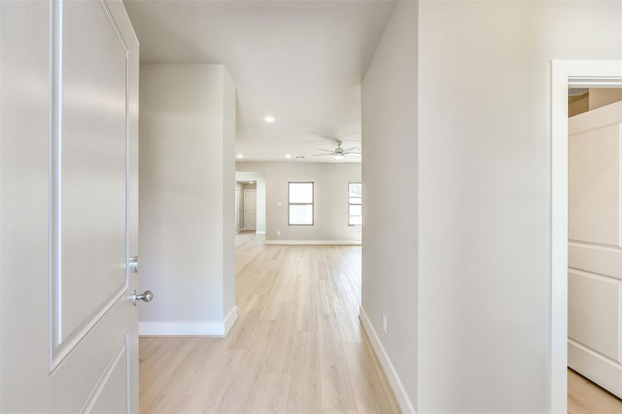 Bright and airy entryway with light-toned wood floors and a seamless flow into the open living space.