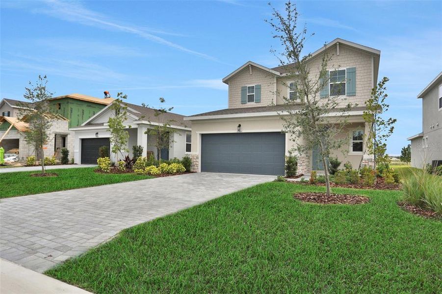 Front exterior of a new home in Turnleaf, Punta Gorda, FL, highlighting curb appeal (Image 23).