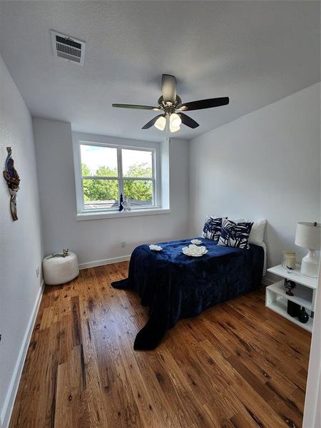 Bedroom featuring hardwood / wood-style flooring and ceiling fan